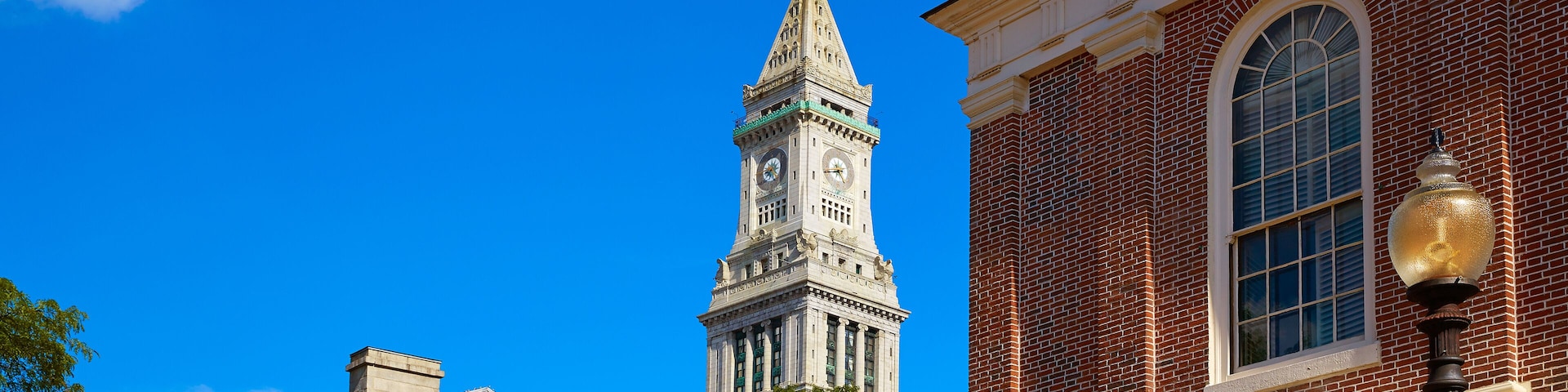 A historic building with a clock tower and the sign "CINCY MARKET" in front.