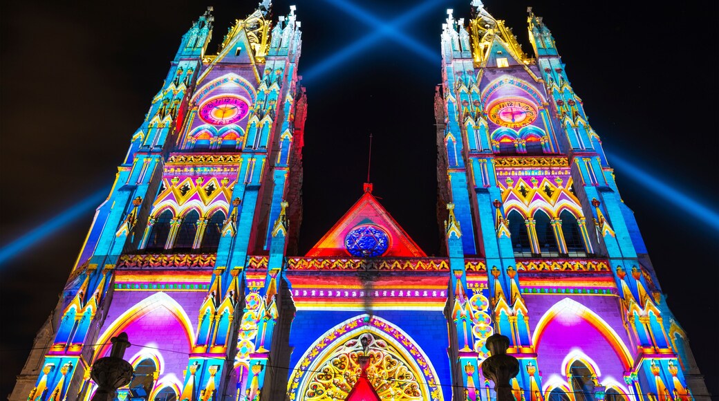 The neo - gothic style Basilica of the National Vow (Basilica del Voto Nacional) illuminated with colorful lights during the Quito light festival.