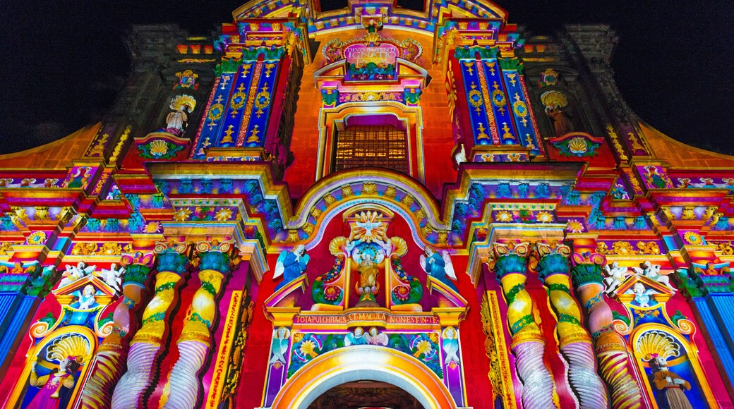 The facade of the Compania de Jesus church illuminated with colorful lights during the light festival, Quito, Ecuador.