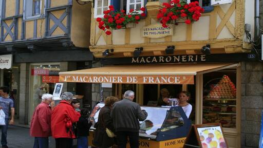 Quimper which includes signage, street scenes and a city