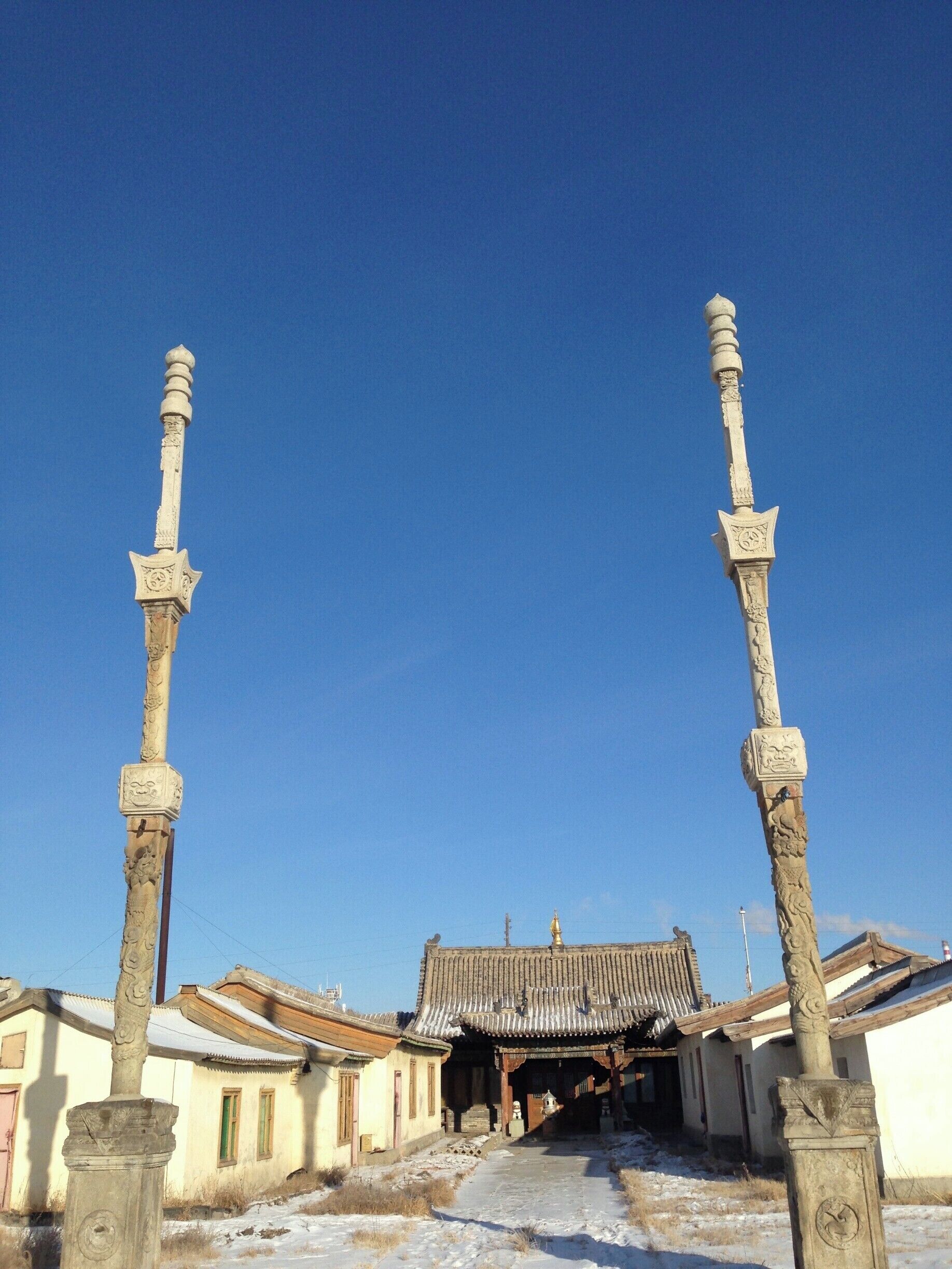 I haven't seen columns like these outside other Buddhist temples around Ulaanbaatar. Mostly you'll find a wall to the south to keep out the bad spirits. There wasn't anyone to ask why they had the columns although I know this is a special area for the birthplace of the Mongolian hero, Sukhbaatar.