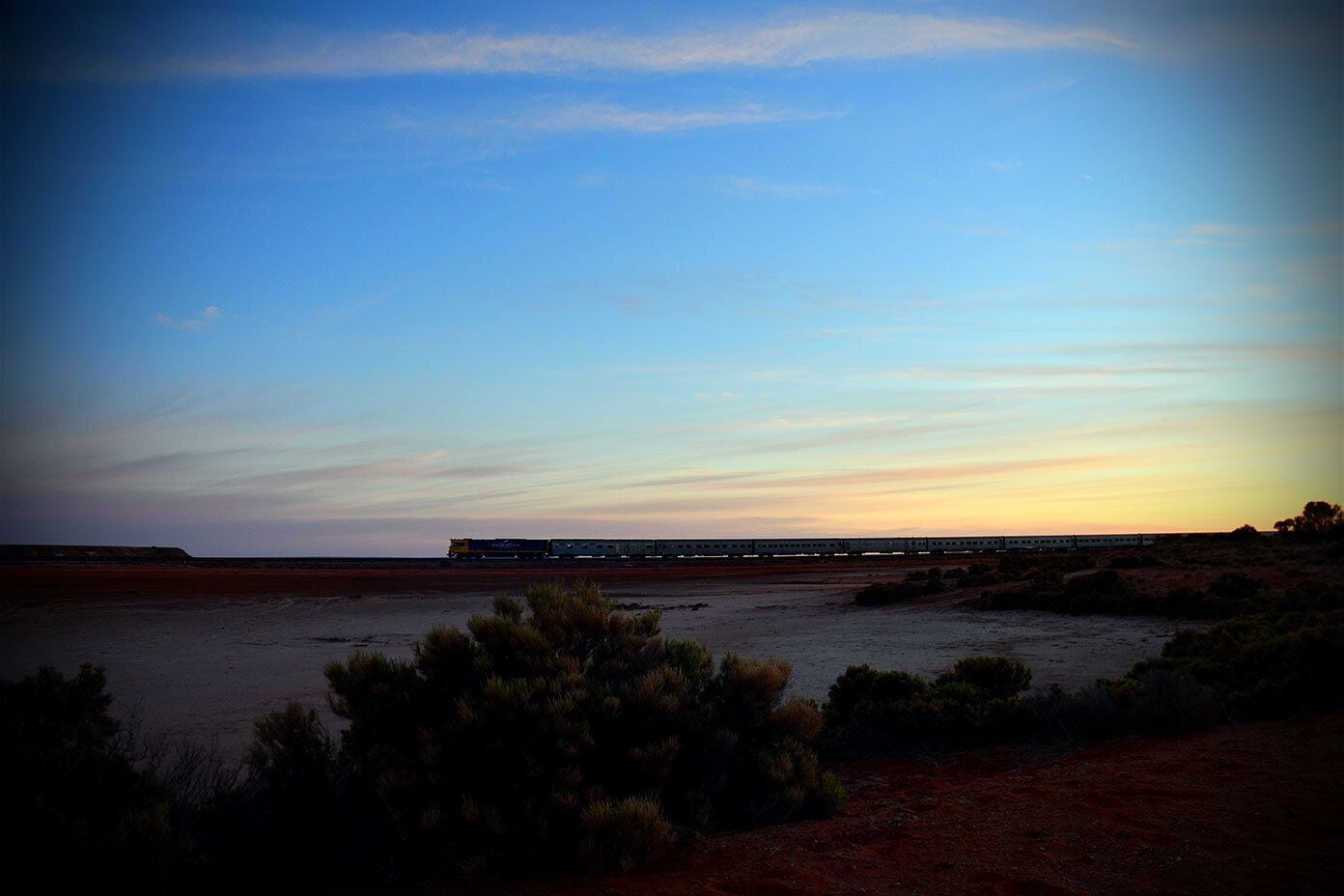 The Ghan passenger train steaming past Lake Hart in outback south Australia, the dry, salty shores of which I just happened to be camping on at that very moment.
