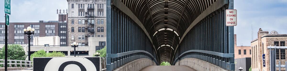 The 4th Street Bridge covered walkway in downtown Waterloo, Iowa on a beautiful summer day with clouds in the sky.