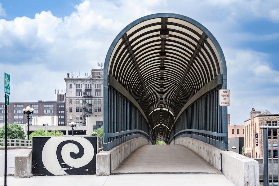 The 4th Street Bridge covered walkway in downtown Waterloo, Iowa on a beautiful summer day with clouds in the sky.