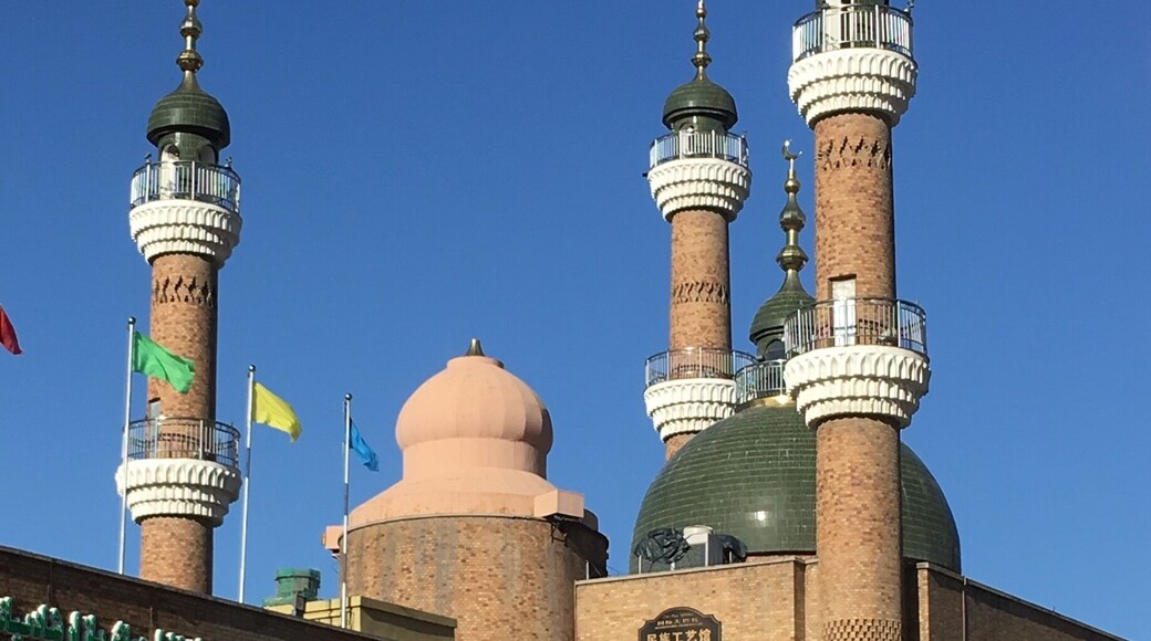 In the courtyard outside the Grand Bazaar in Urumqi. The Mosque in the background.