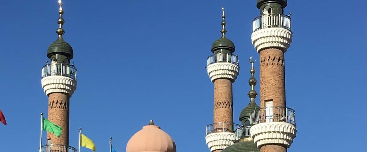 In the courtyard outside the Grand Bazaar in Urumqi. The Mosque in the background.