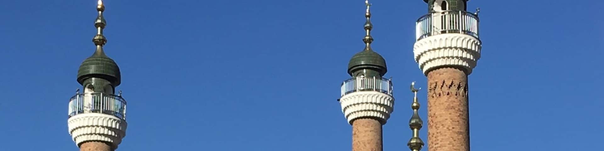 In the courtyard outside the Grand Bazaar in Urumqi. The Mosque in the background.