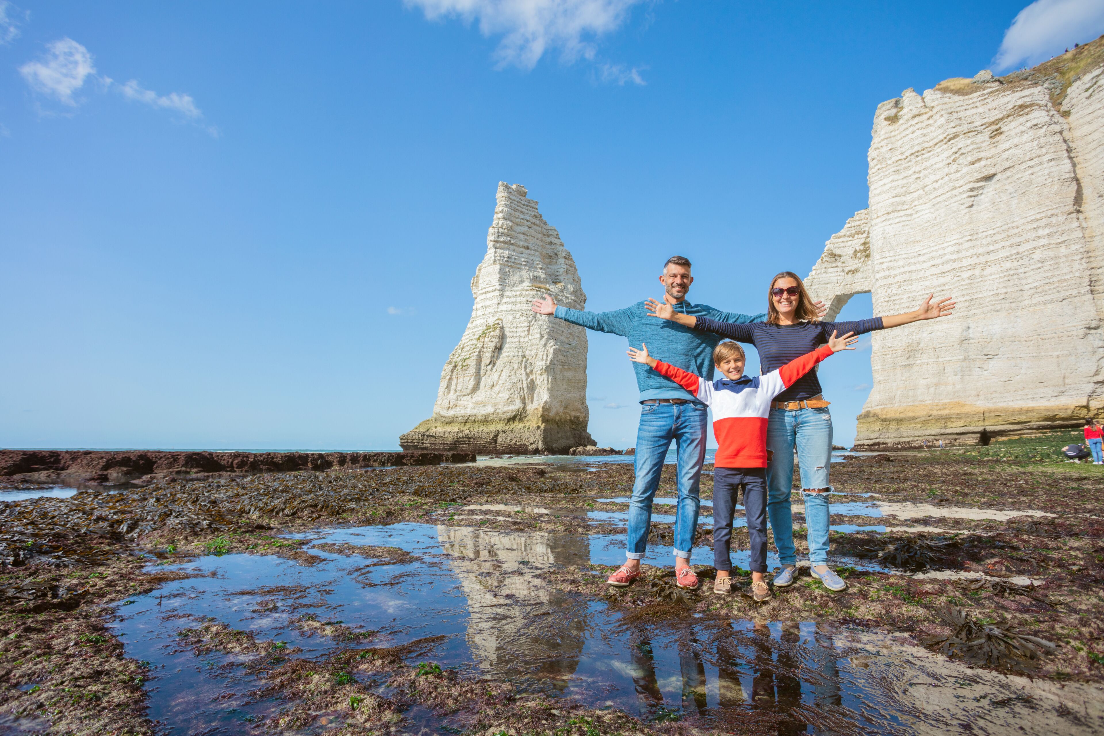 Happy family of three in the Etretat. France