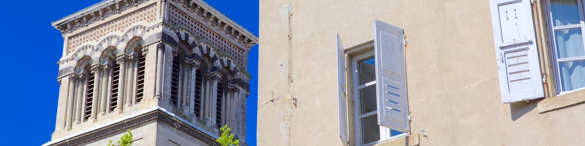 A historic building with ornate architecture and a weather vane on top.