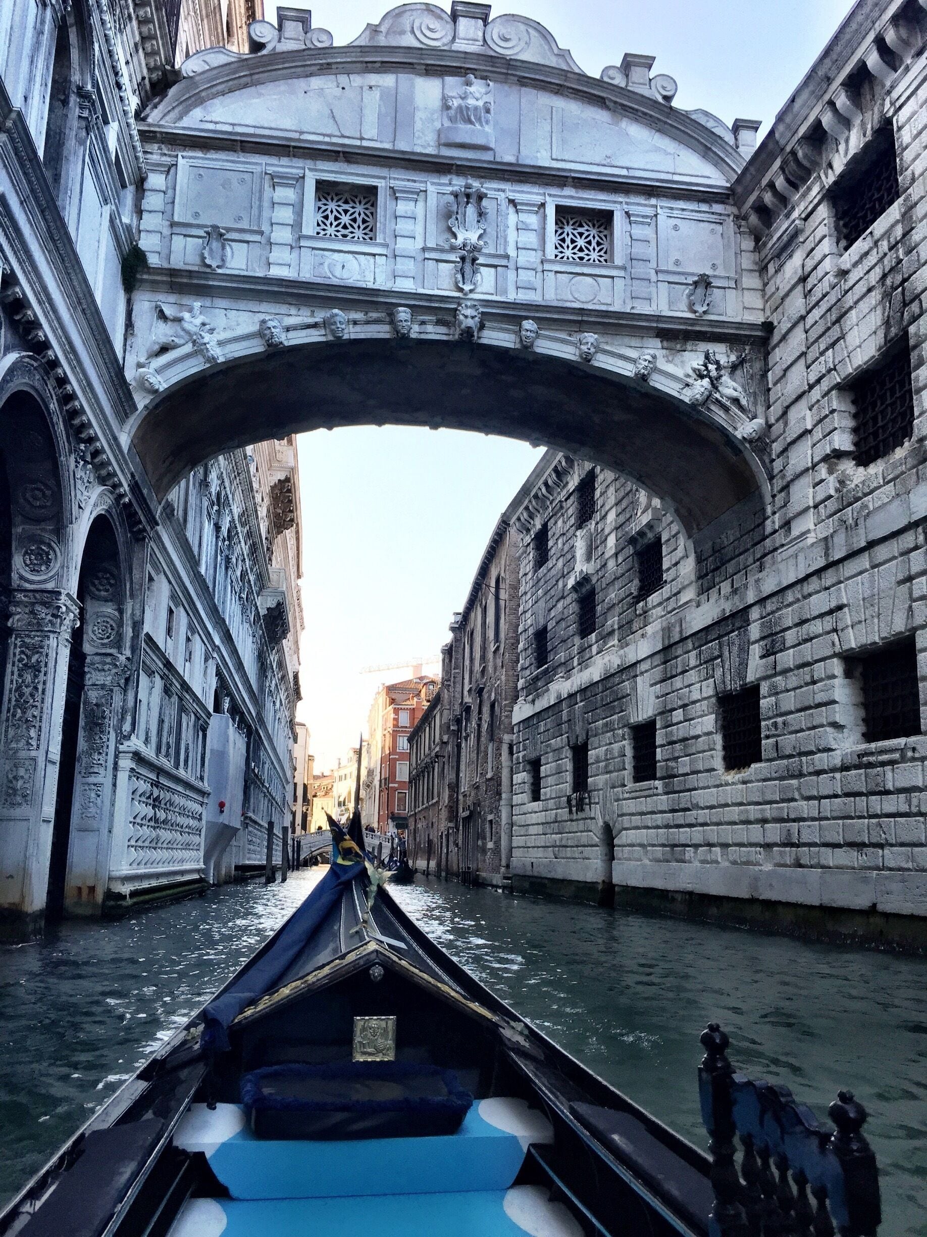 Gondola ride under The Bridge of Sighs in Venice.  This bridge connects the prison to the interrogation rooms in the Doge's Palace. Through the stone barred windows of the bridge, convicts saw their last views of Venice before they were imprisoned. 