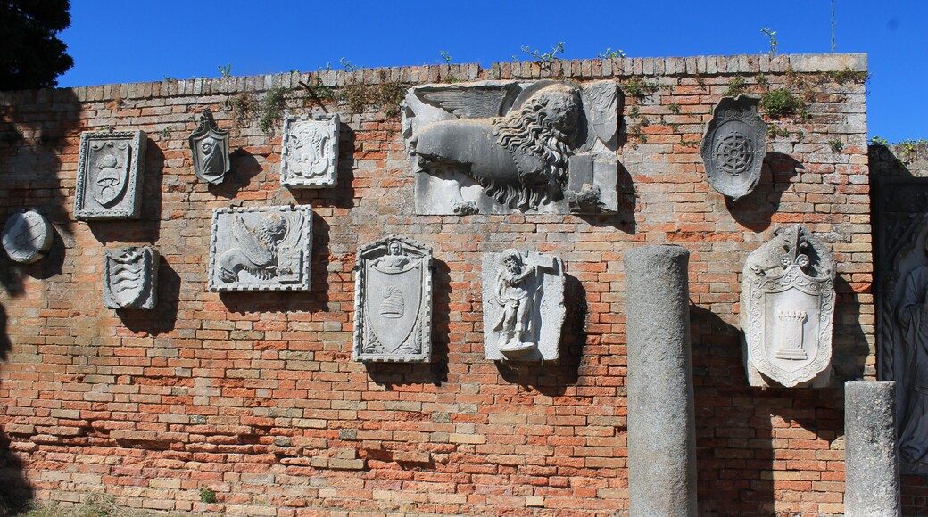 Funky wall of ancient findings, mounted on an outdoor museum wall on a cute little Venetian Island!