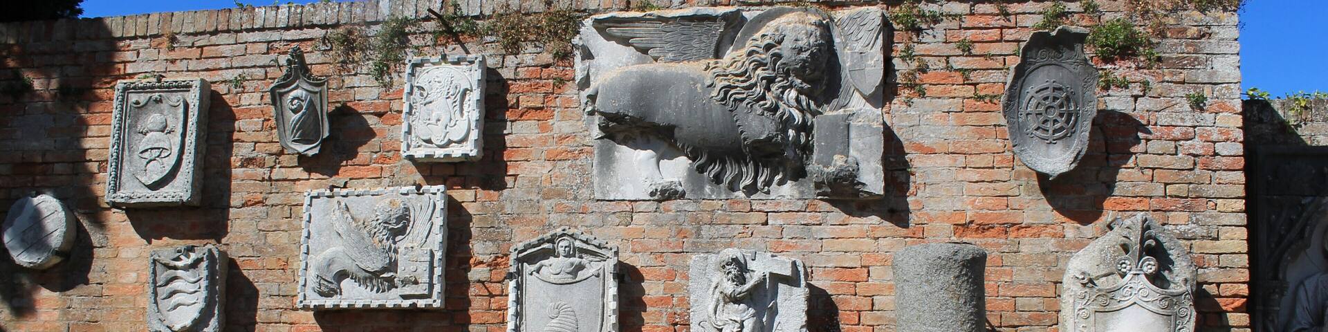 Funky wall of ancient findings, mounted on an outdoor museum wall on a cute little Venetian Island!
