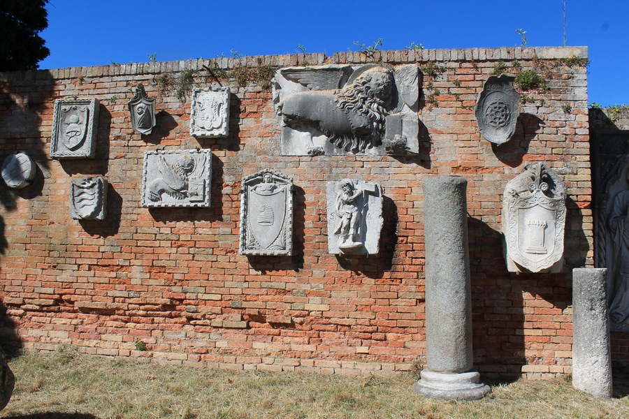 Funky wall of ancient findings, mounted on an outdoor museum wall on a cute little Venetian Island!