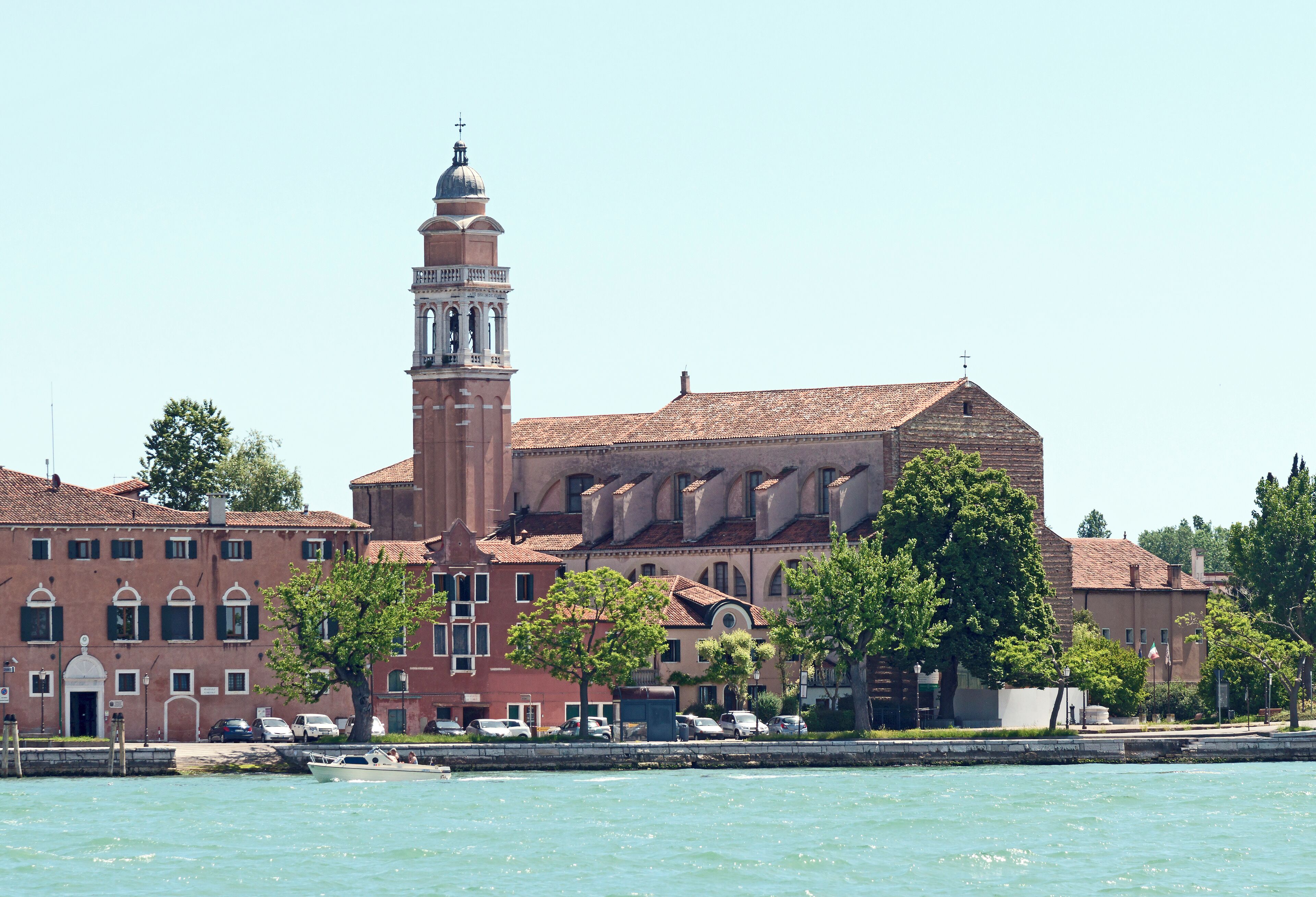 A historic building with a prominent tower and a waterfront.