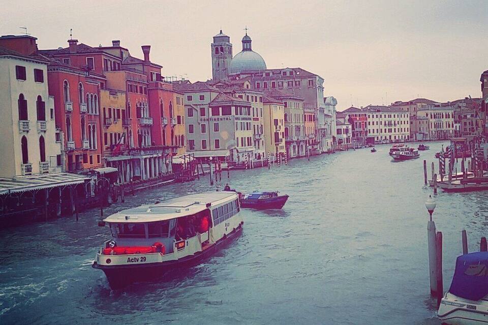 A canal in Venice with colorful buildings and boats.