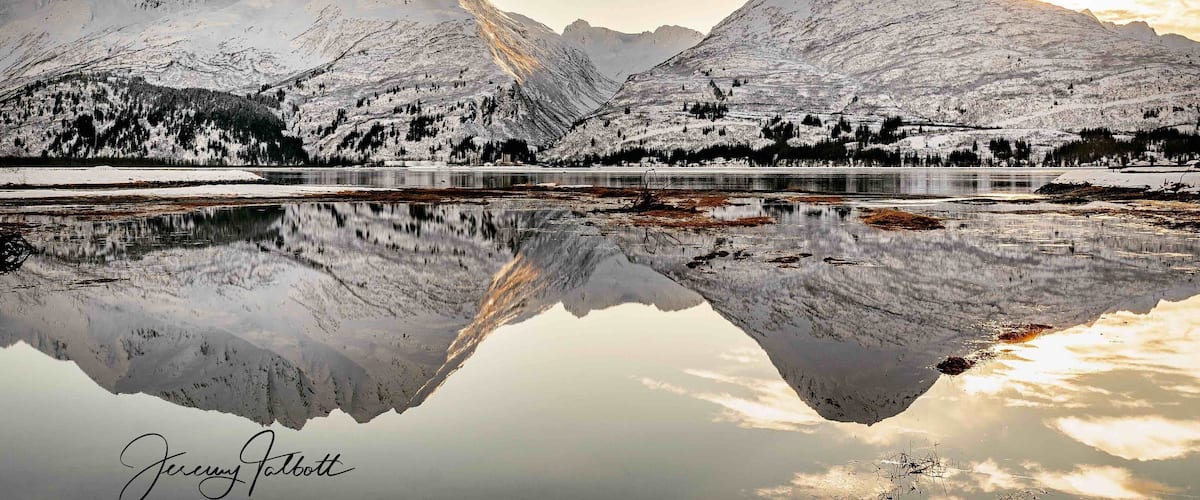 Winter reflecting the Chugatch Mountains onto Prince William Sound. The Old Town Valdez site is a great place to spot bears, and other wildlife during warmer months!