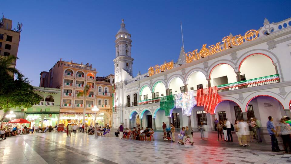 A historic plaza with a prominent clock tower and the 'Viva México' sign.