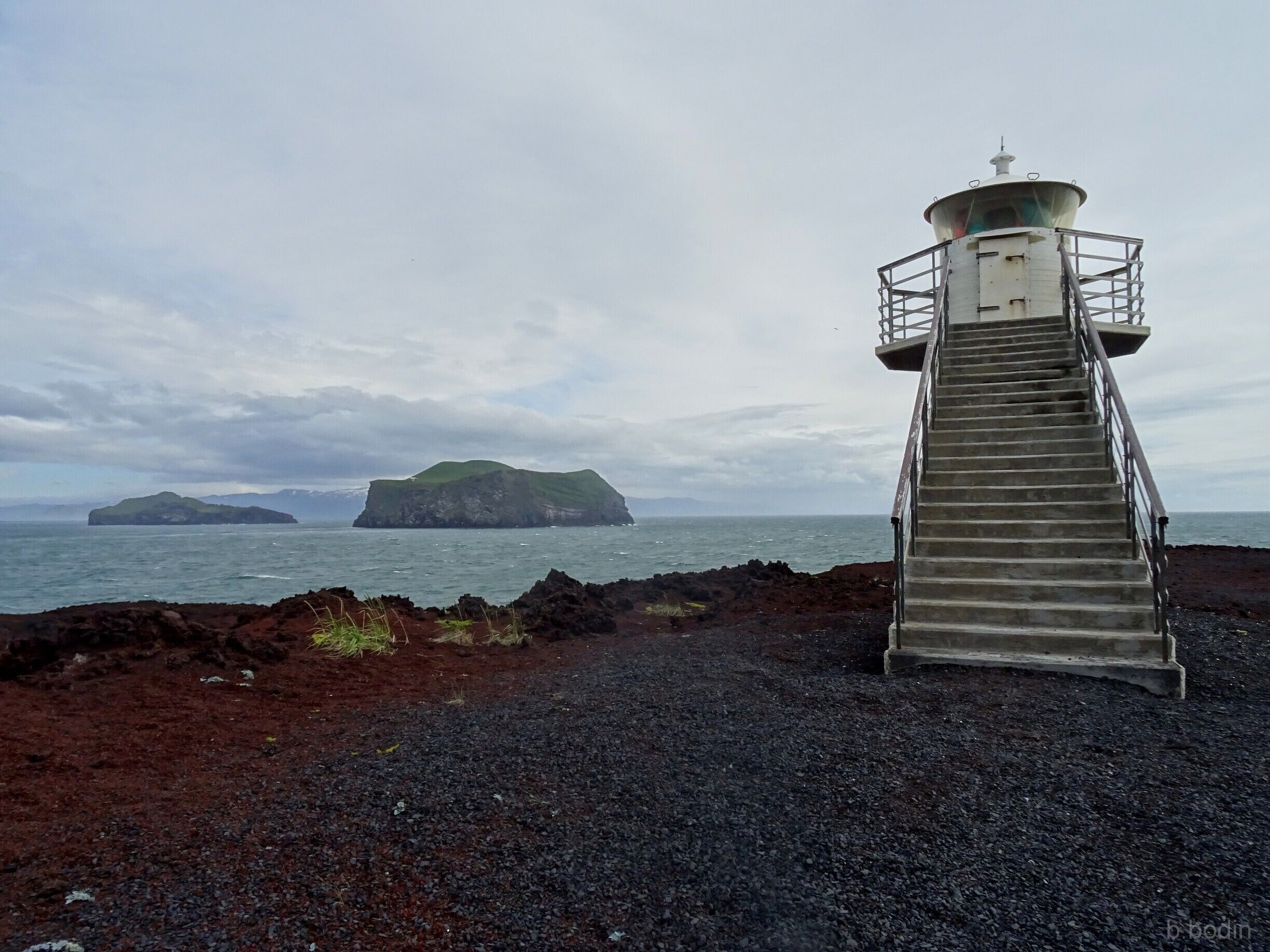 A lighthouse at the vulcano shore of the Vestmannaeyjar island. 