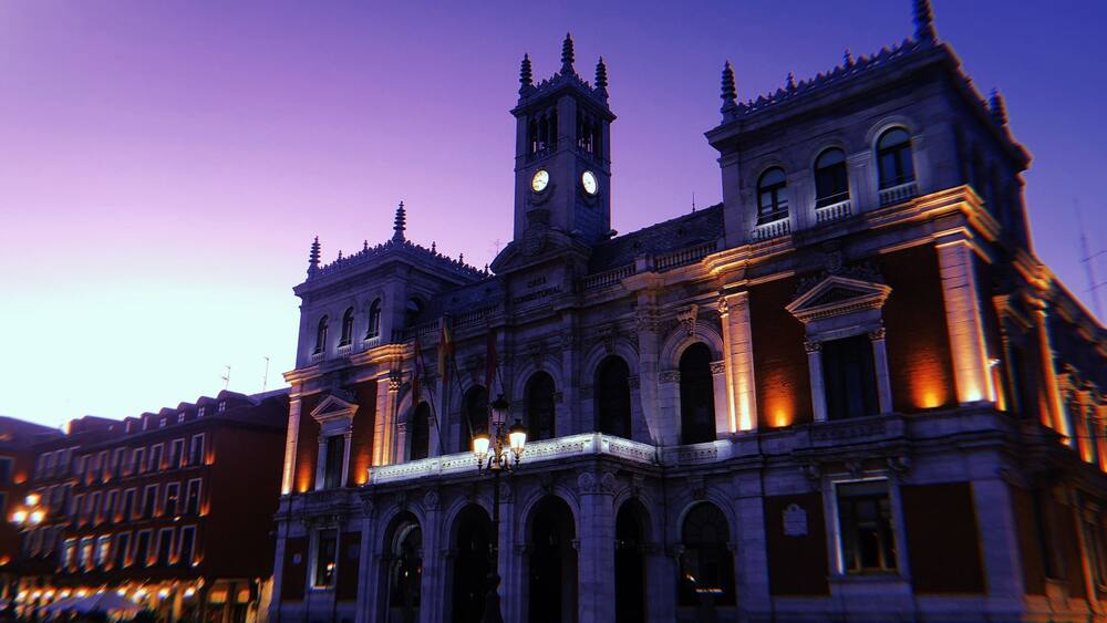 A historic building with a clock tower and arched windows.