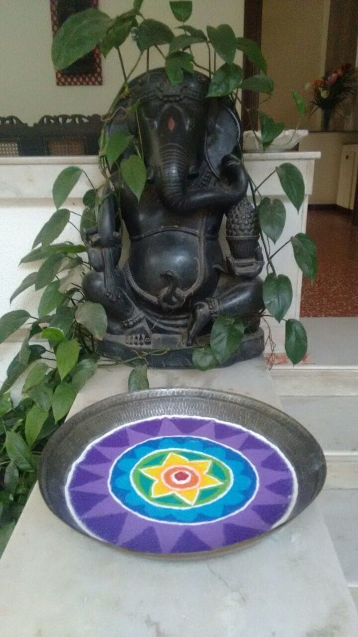 A colorful "Rangoli" done by my 14 year grand daughter this Diwali festival at the entry of her home to greet guests. 
