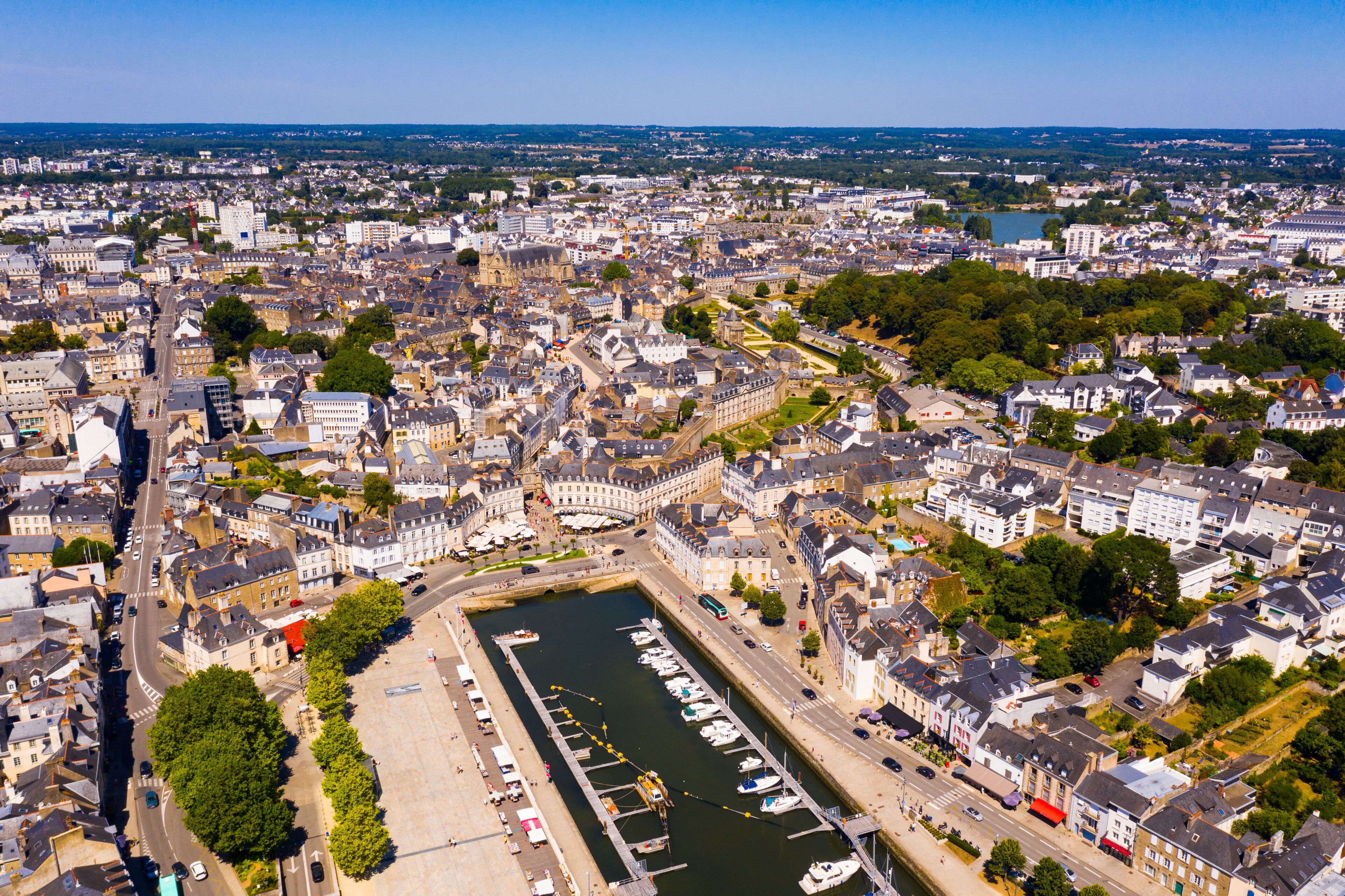 An aerial view of a city with a prominent river, historic buildings, and a dense urban layout.