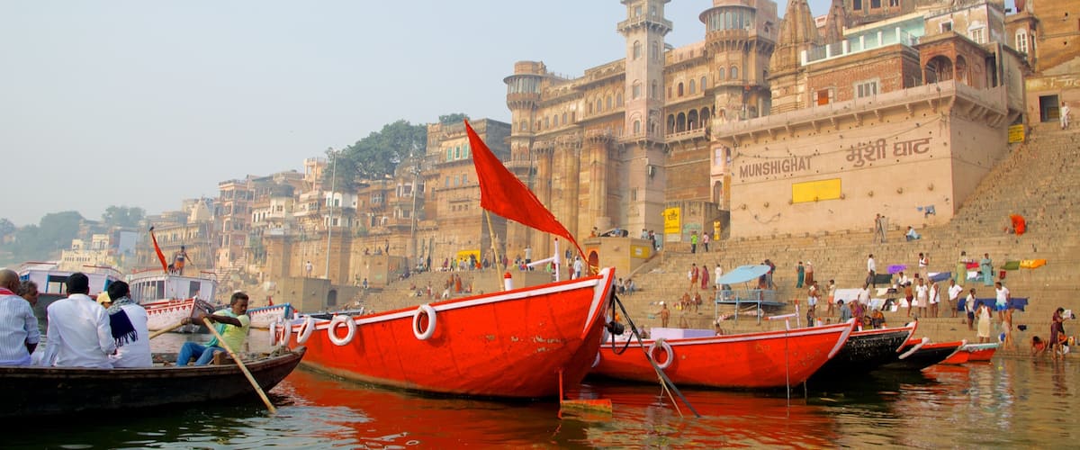 A river with boats and a historic building in the background.