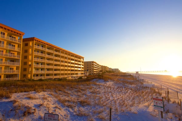 Fort Walton Beach showing a sandy beach, a hotel and a sunset