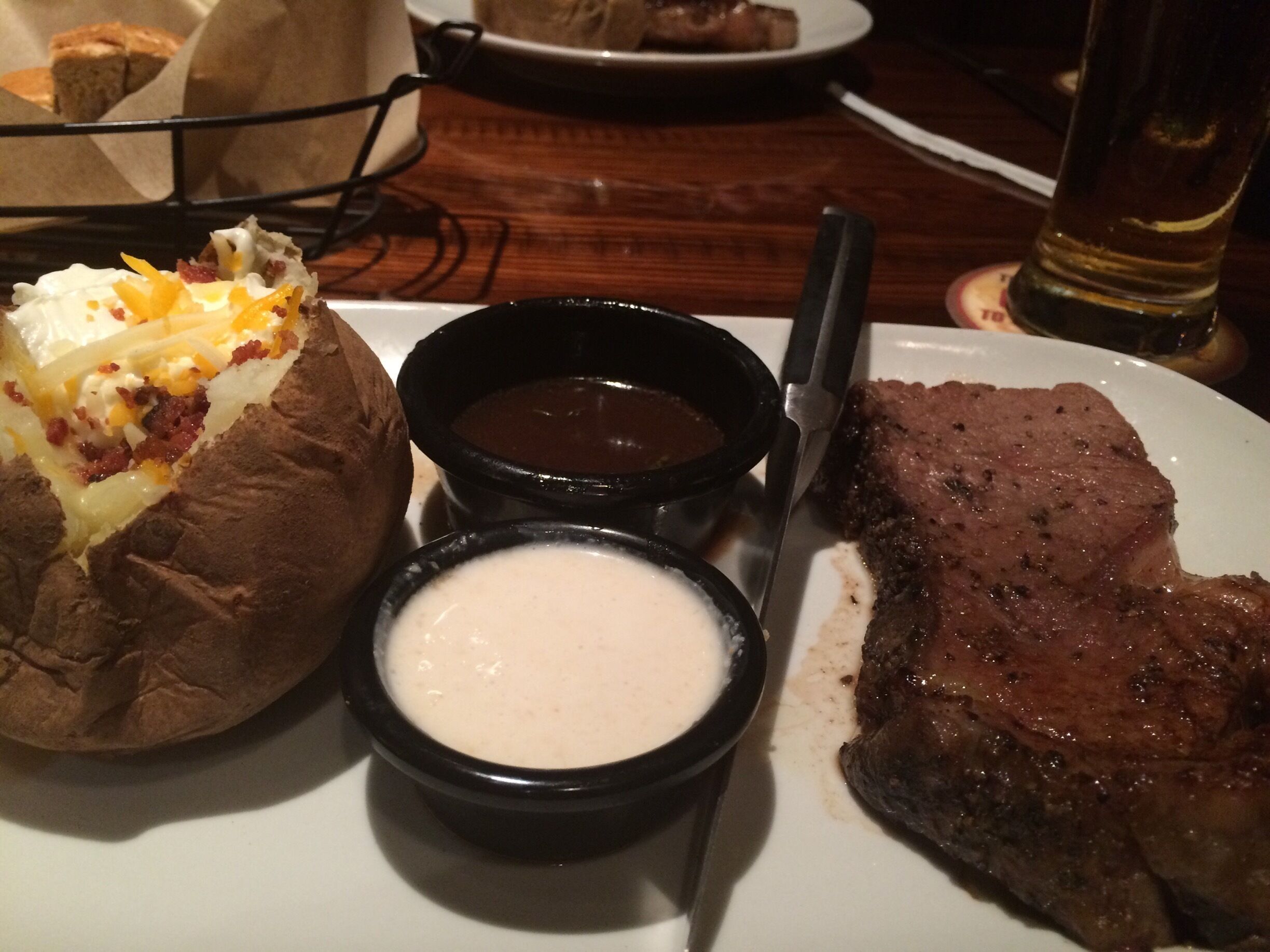 Prime rib loaded baked potato and a pint