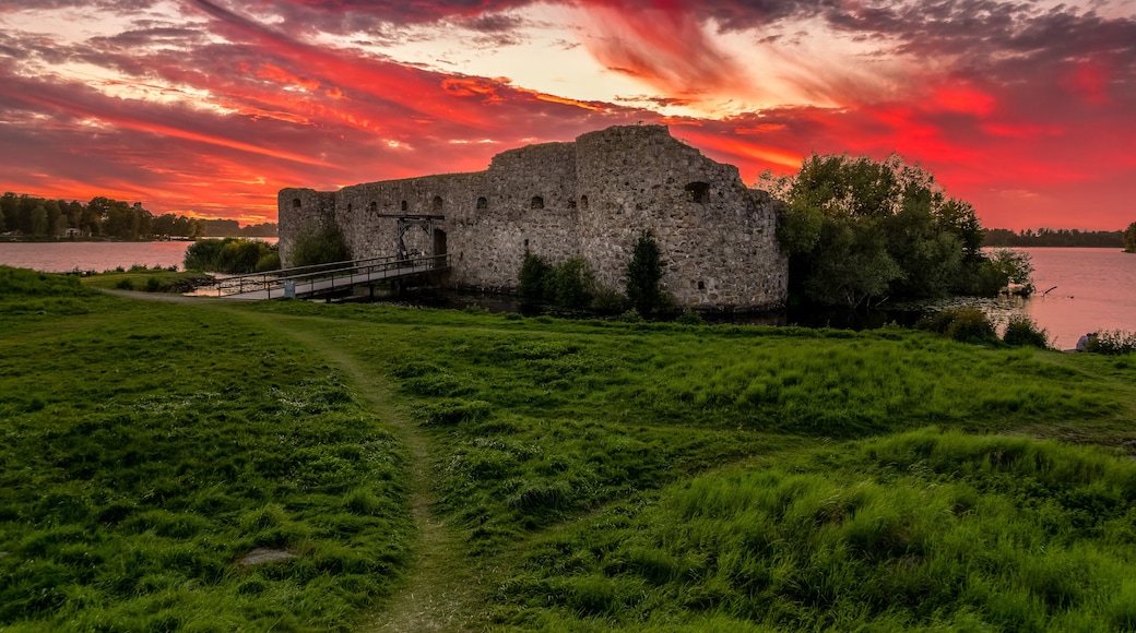 Aerial view of Kronoberg castle ruin on Helgasjön lake in Växjö Municipality in southern Småland, with dramatic sunset sky