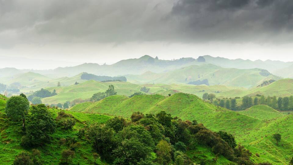 Rolling green hills with a cloudy sky.