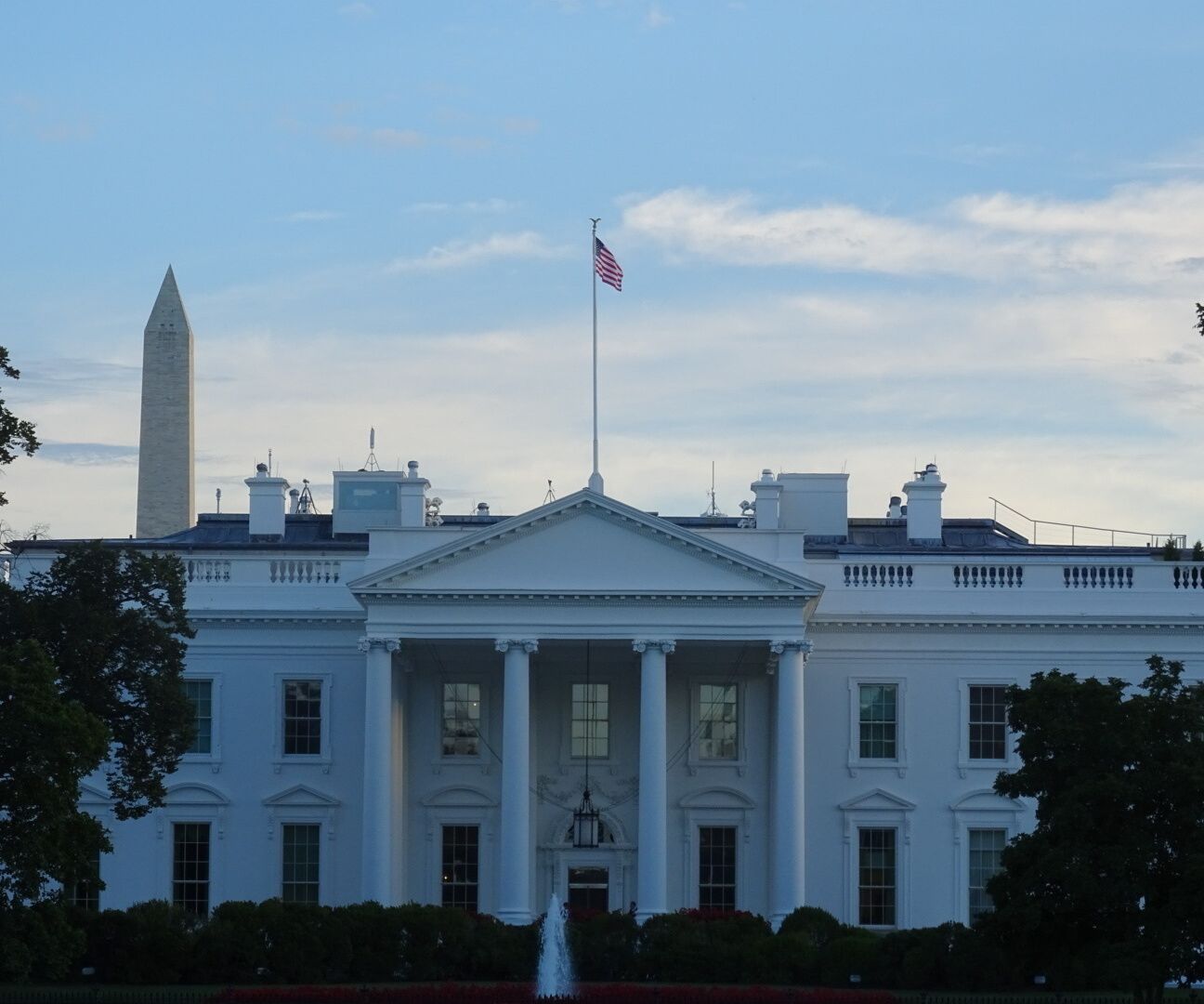The front of The White House with the ubiquitous Washington Monument making a guest appearance. 

1600 Pennsylvania Avenue is probably one of the most famous addresses in American history.

Since John Adams in 1800, The White House has been the official residence of every United States President.

Despite being constructed out of sandstone painted white, the structure took significant fire damage just 14 years after its completion.

The White House has expanded to include the East and West Wing as well as taking over the neighboring Eisenhower Executive Office Building.
