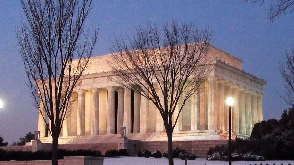 The Parthenon in Athens, Greece, illuminated at dusk.