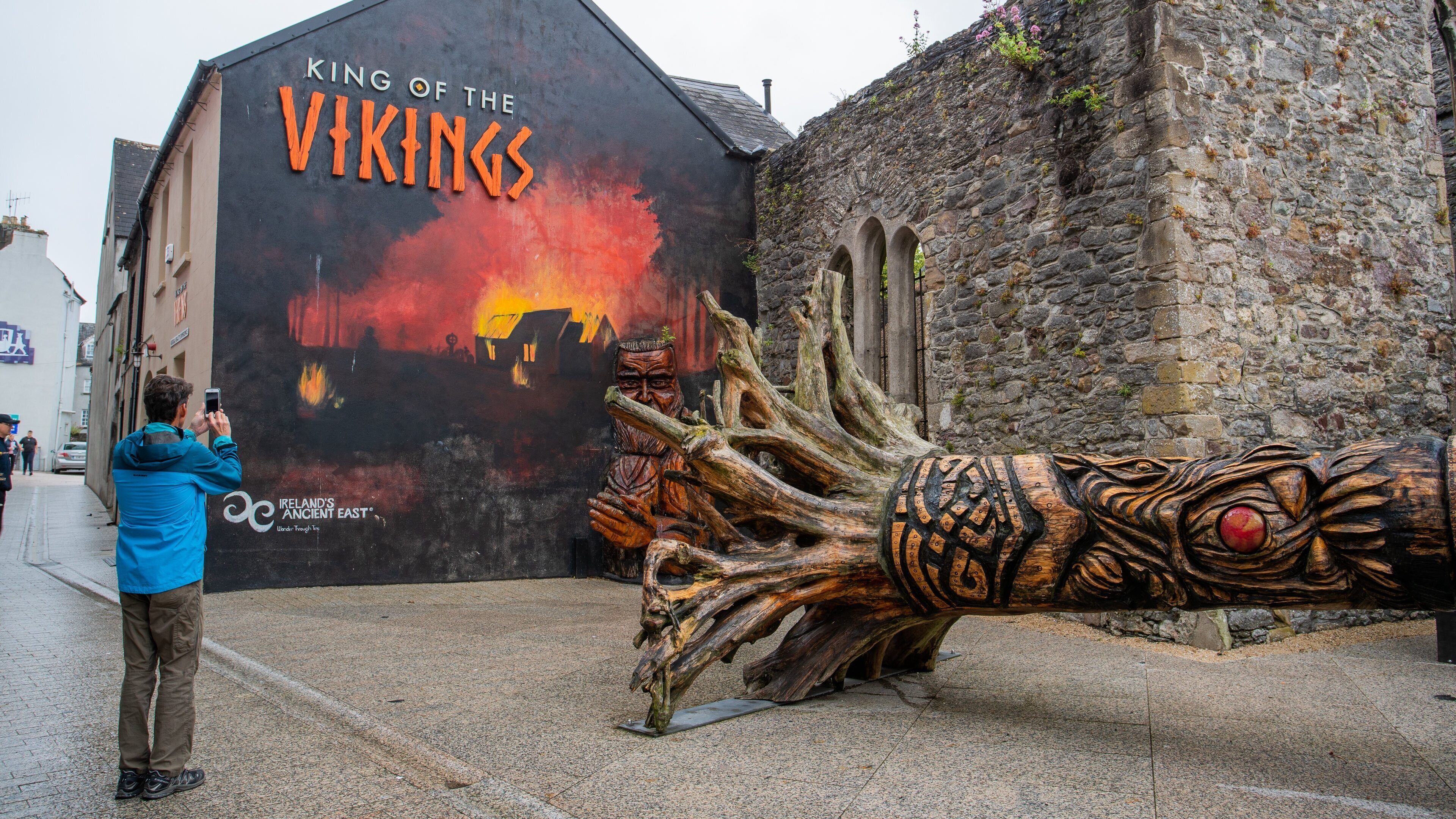 Waterford featuring outdoor art and signage as well as an individual male