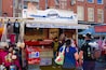 A street market with a stall named "Rudi's Original Stroopwafels" at Albert Cuypsstraat 180, Amsterdam.