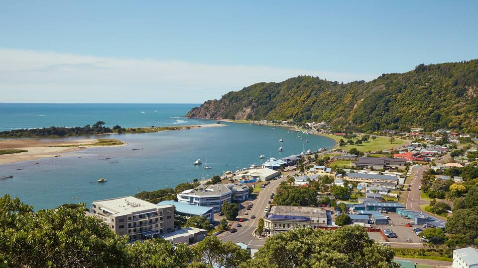 A coastal town with a bay, boats, and buildings.