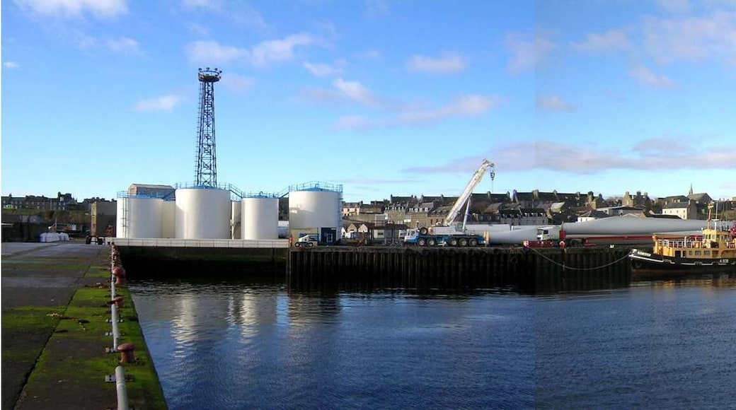 Wick Harbour, Scotland. The ex-RMAS Fleet Tender Ilchester is to the left, with windmill blades behind her.