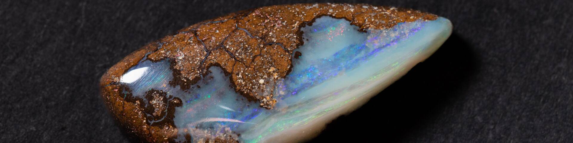 Colorful boulder opal gem from Winton Australia on black background