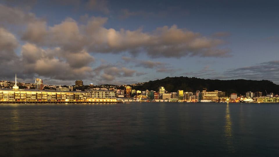A predawn view of the recently rebuilt Chaffers Wharf, with the CBD of Wellington behind, as seen from a small breakwater near Freyberg Pool