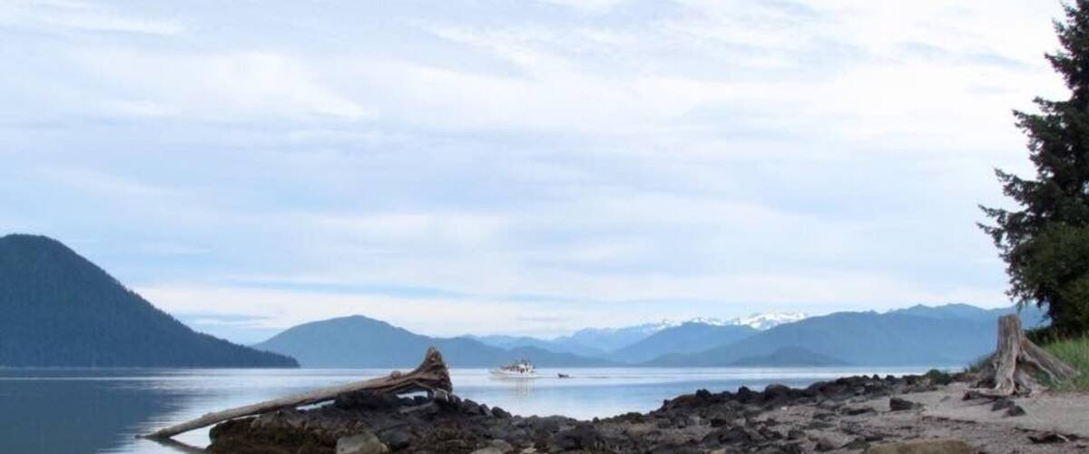 This is a view from Petroglyph Beach in Wrangell Alaska. It is a short walk from the centre. To be honest there are very little original carvings left on the site. They have been moved to the museum for preservation. The few on the beach are very faded. The beach is still worth checking out. There is a platform with replicas and a lot of information. We collected ferns and got some butcher paper and did a rubbing of a replica. It came out really well.