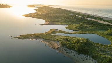 Aerial view of beach dividing Quonochontaug Pond and Atlantic Ocean at sunrise, Weekapaug, Westerly, Rhode Island, USA