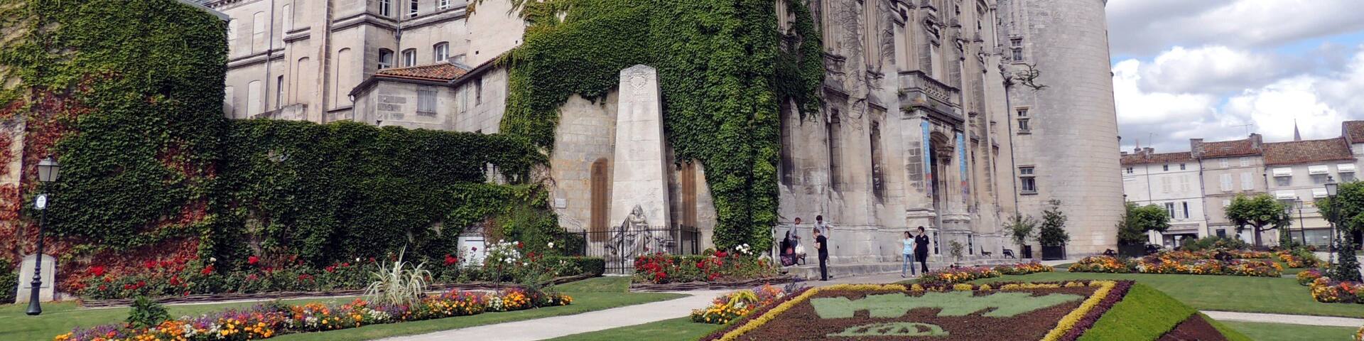 A historic building with a prominent tower and ivy-covered walls.