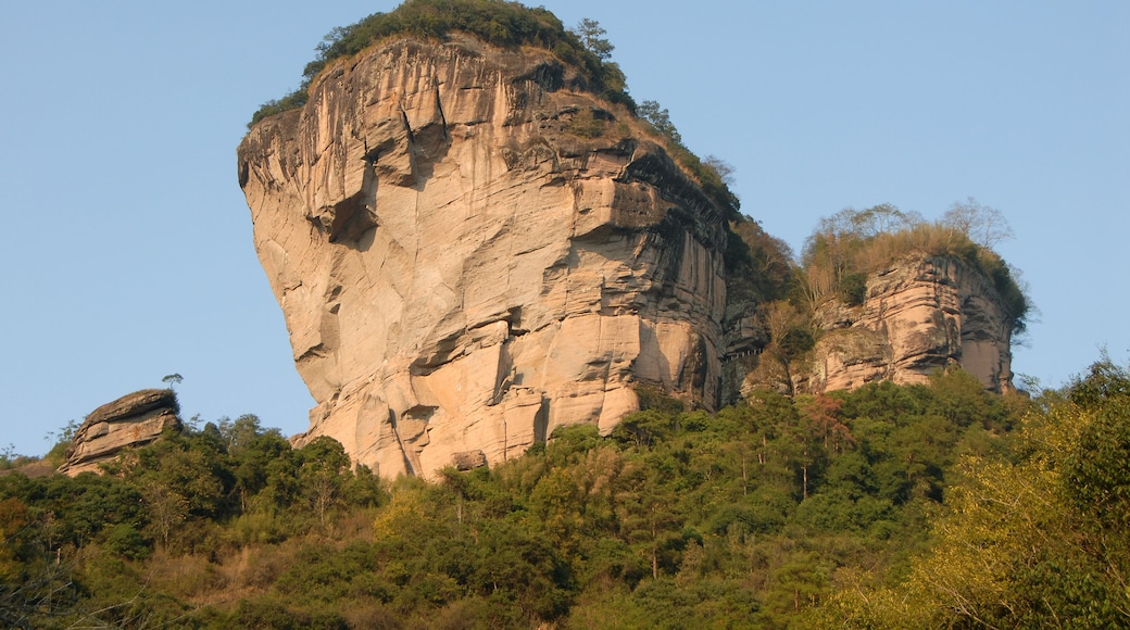Wuyishan mountains in Fujian Province, China. View of DaWang Peak (Great King Peak) in Wuyi mountains a UNESCO World Heritage site. Close up view with forest in the foreground. Wuyishan, China.