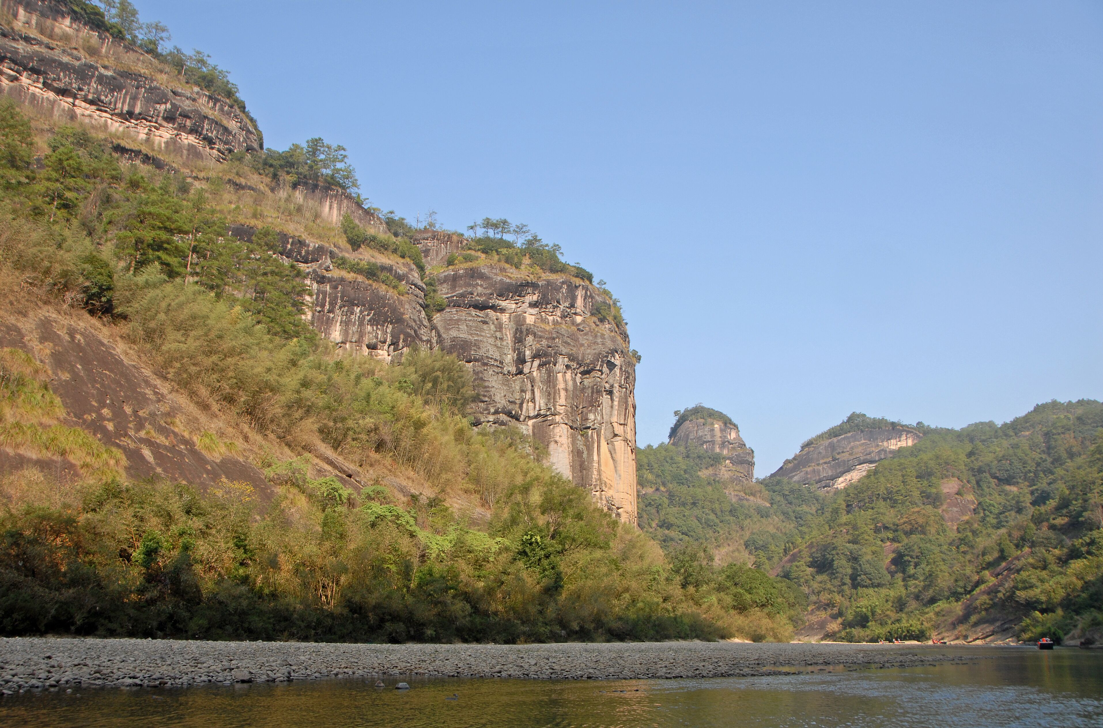 Wuyishan mountains in Fujian Province, China. View of the scenic Wuyi mountains from a raft on the Nine Bends River or Nine Twists Stream. Wuyi mountains are a UNESCO site in China.