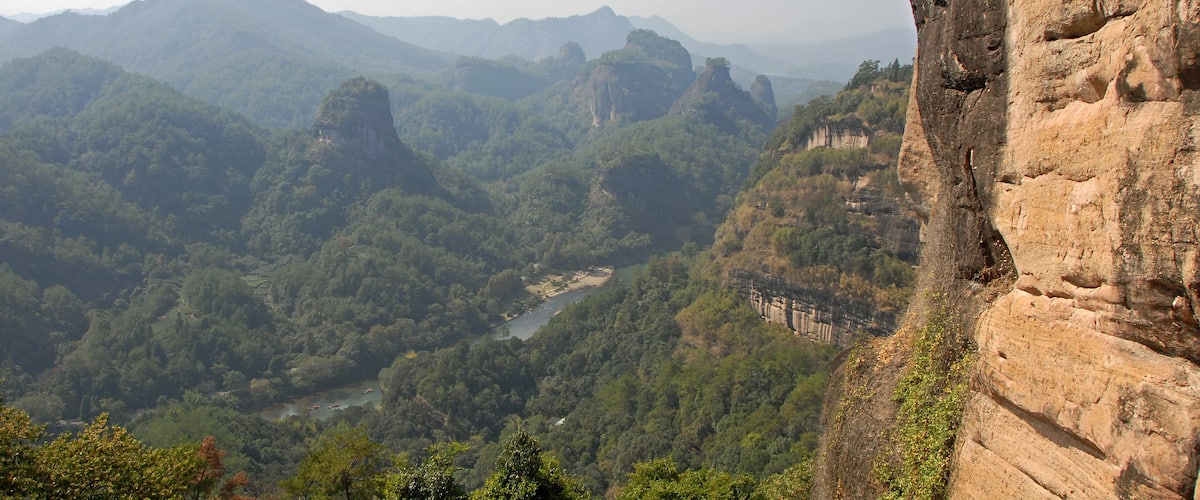 Wuyishan mountains in Fujian Province, China. On the path to DaWang (Great King) Peak. View over the mountains with Nine Bends River or Nine Twists Stream below. Wuyishan is a UNESCO site in China.