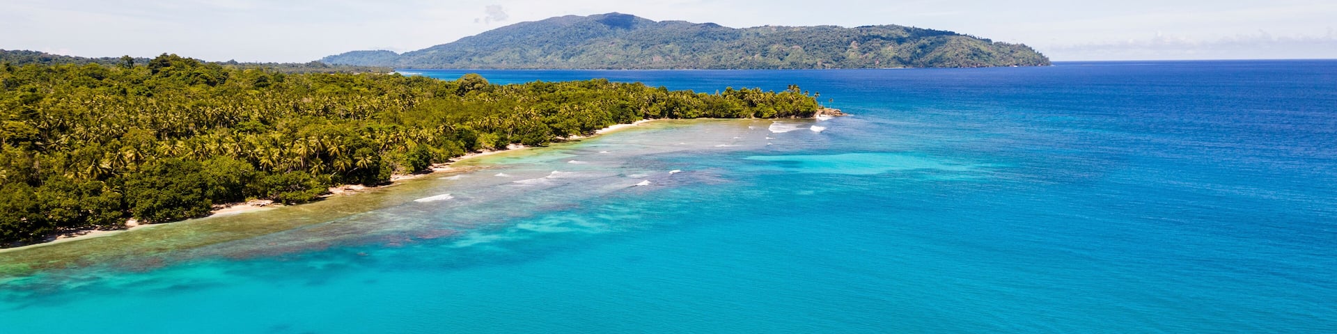 Aerial Drone View of Turquoise Sea of Musho Island, Wewak East Sepik Province, Papua New Guinea.