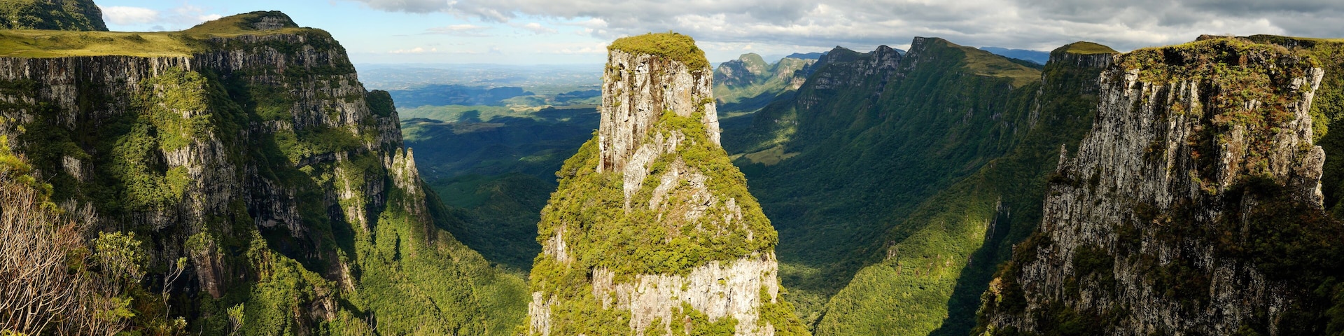 A canyon with steep cliffs and a prominent central peak.