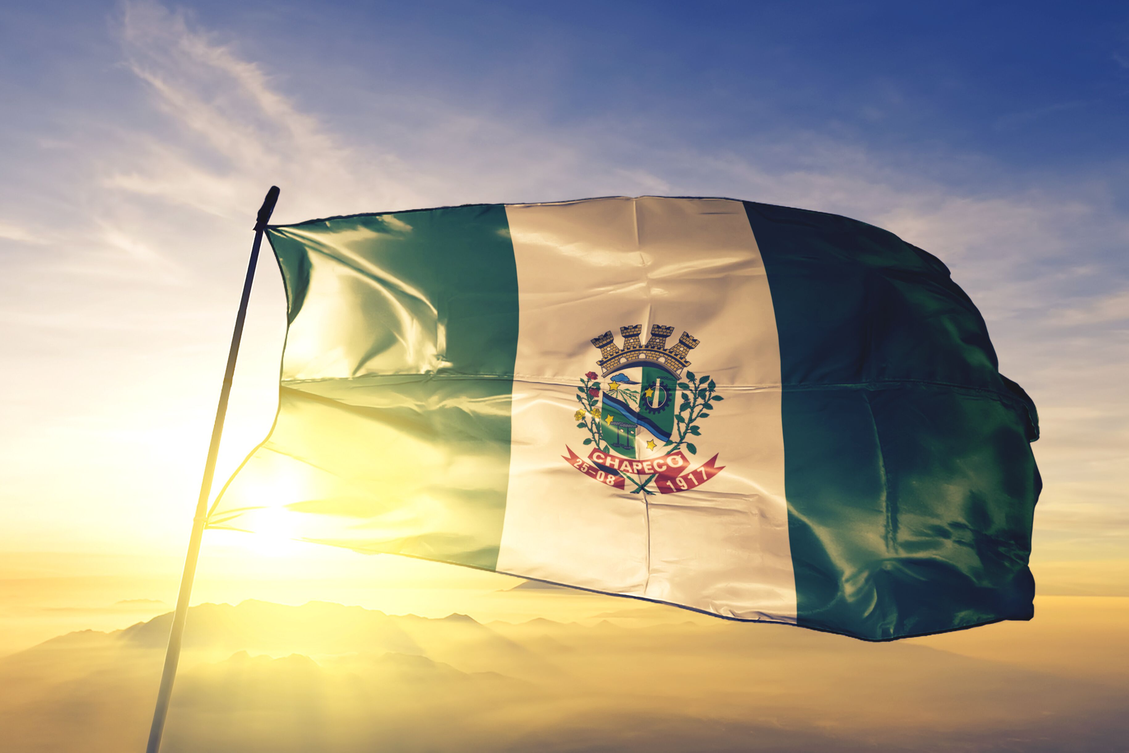 Chapeco of Brazil flag waving on the top sunrise mist fog