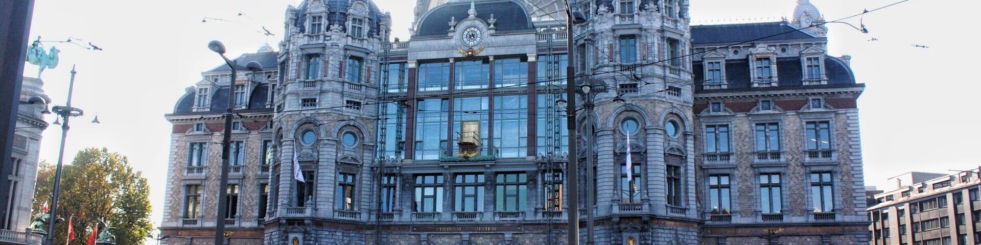 A historic building with ornate architecture, large windows, and a prominent dome.