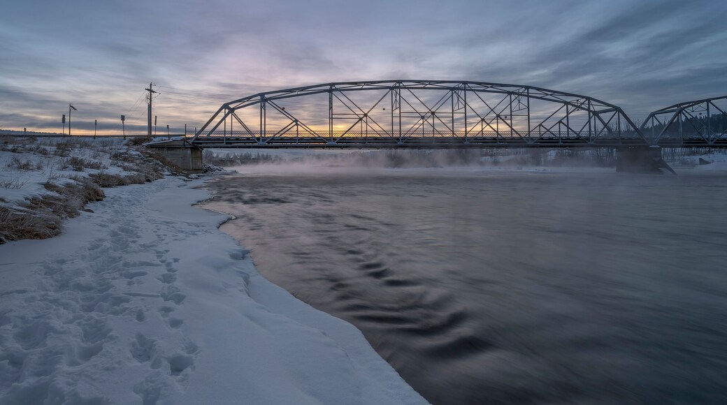 Winter sunrise on the Bow River and a bridge in Cochrane, Alberta, Canada