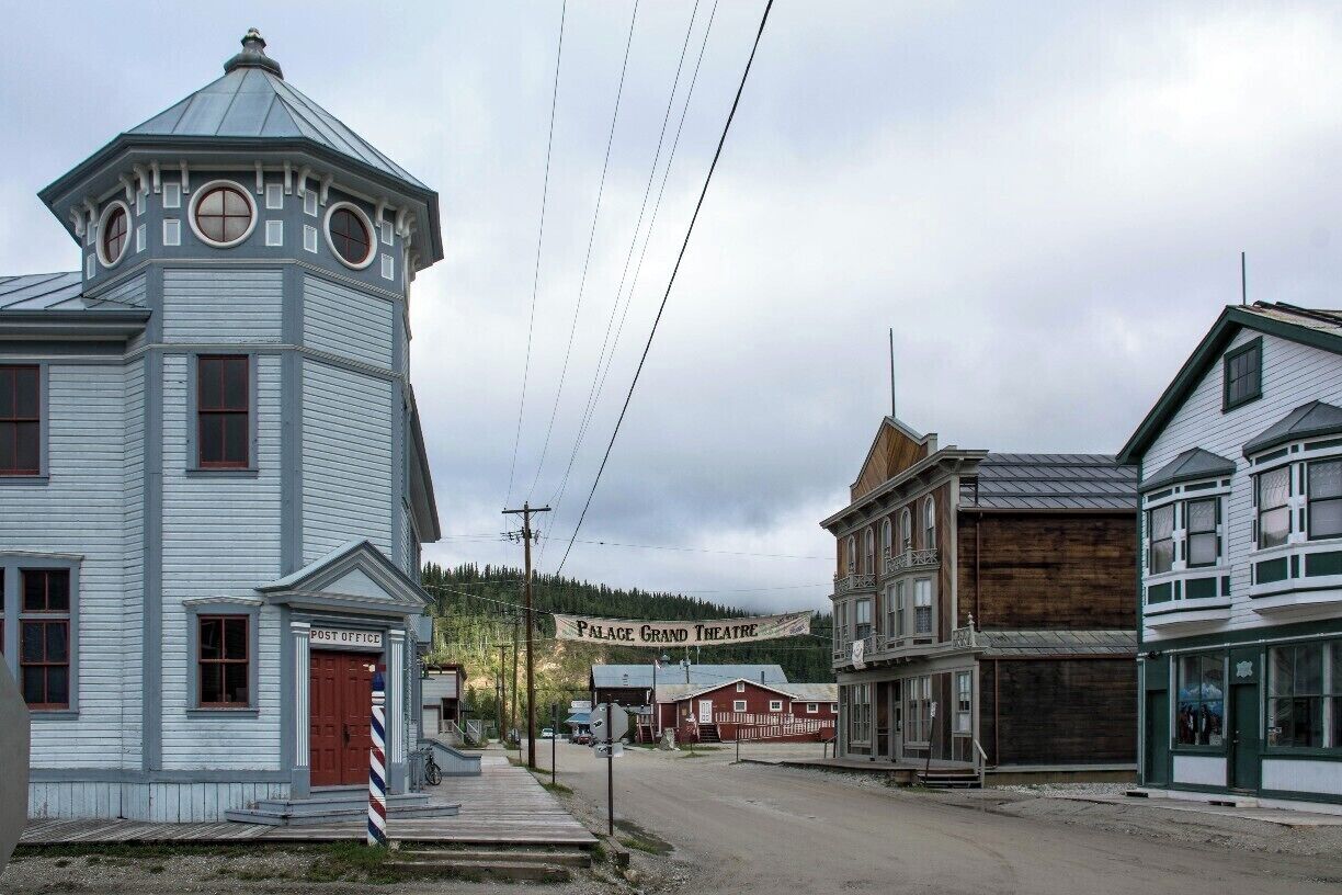 Looking down King St., Dawson City, with the old post office and the Palace Grand Theatre. The buildings and boardwalks help Dawson retain some of its 1890s gold rush character.
http://timeanddestination.com/looking-gold-dawson-city/